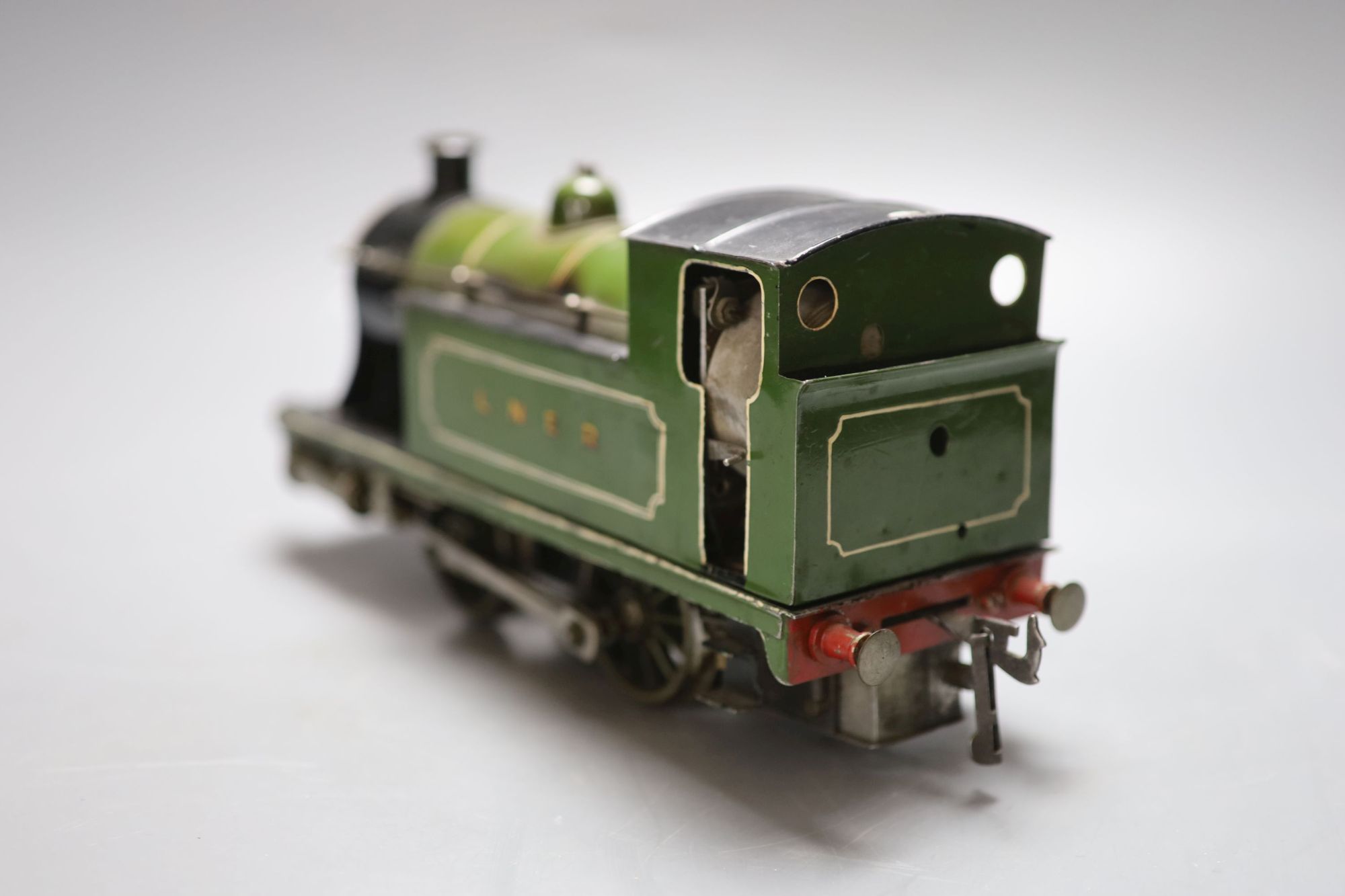 An early 20th century tinplate live steam loco converted to electricity, length 28cm